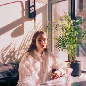Peaceful corner of a room with natural light and plants.